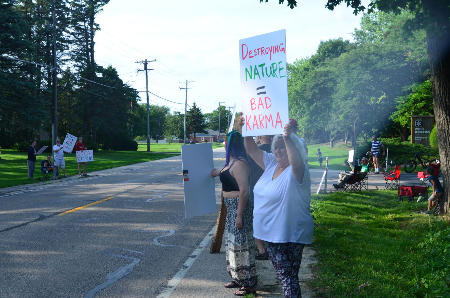 Protestors hold signs